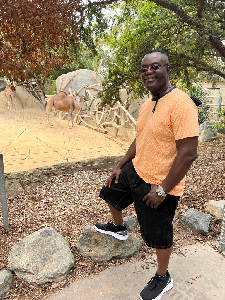 picture of Dr. Colin Ross at the zoo beside a camel