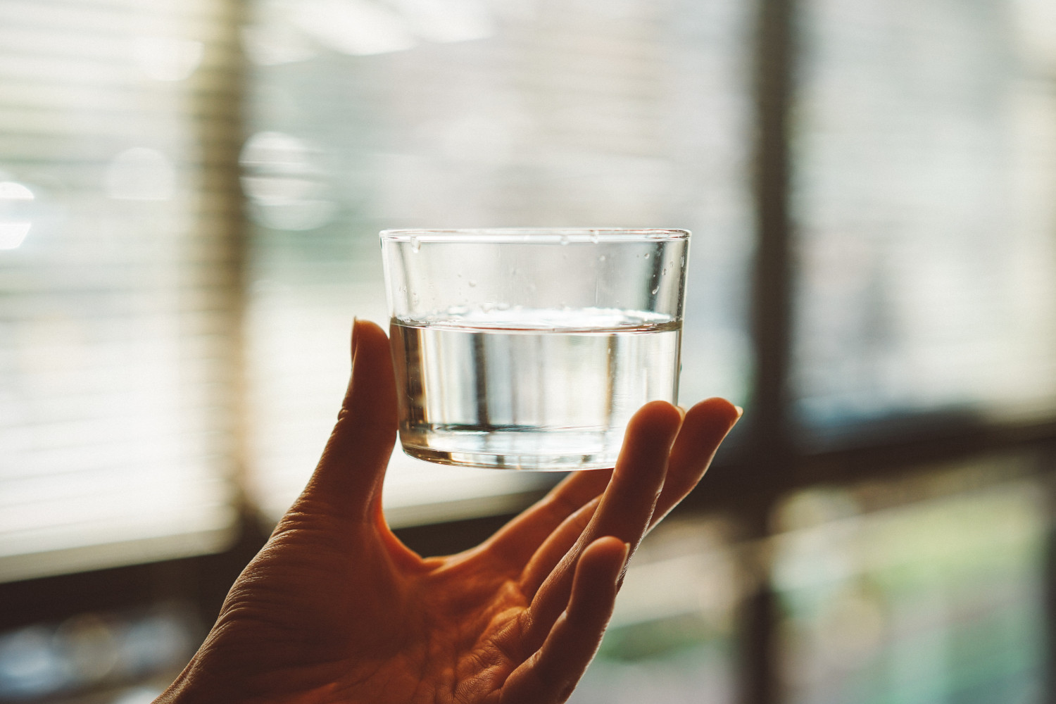 photo of a hand holding a glass of water