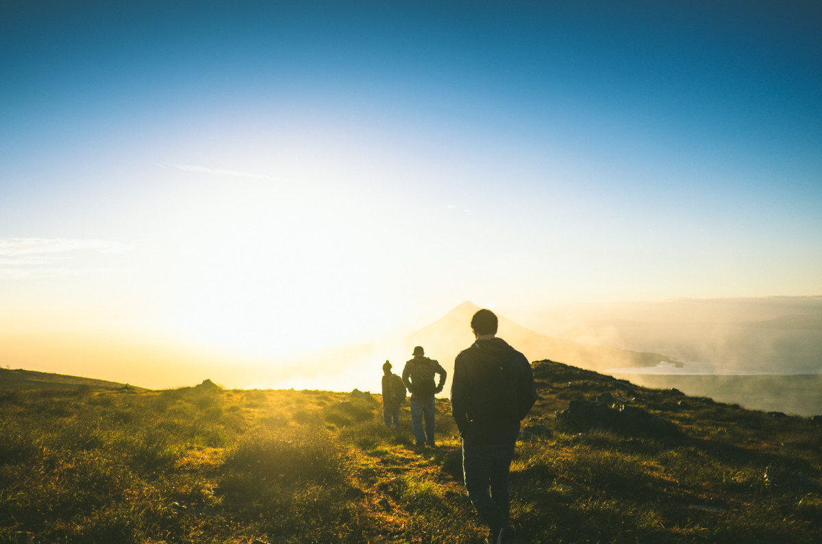 people hiking into the sunset