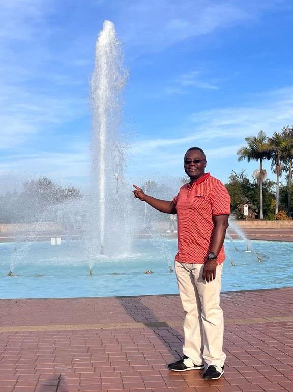 photo of a man next to a water fountain